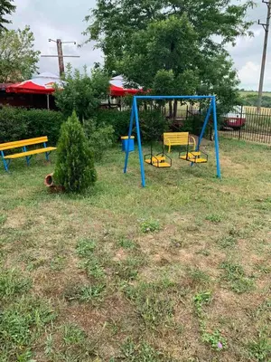 a blue and yellow swing set in a yard at Апартамент Нели in Ravadinovo