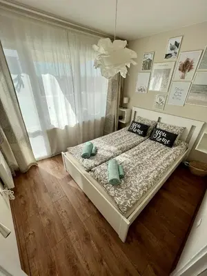 a bedroom with a bed with two pillows and a window at Dockview atelier in Burgas City