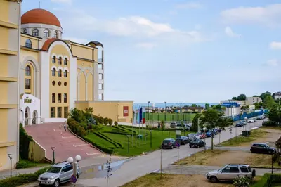 a large building with a street in front of it at ADIRAMAR Apartments in Obzor
