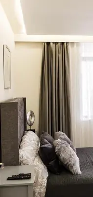 a bedroom with a bed with pillows on it at ADIRAMAR Apartments in Obzor