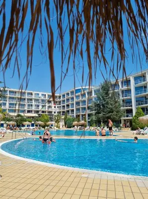 a large swimming pool with a hotel in the background at Atlantis Resort D111 апартамент in Burgas City
