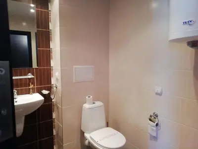 a small bathroom with a toilet and a sink at Atlantis Resort D111 апартамент in Burgas City