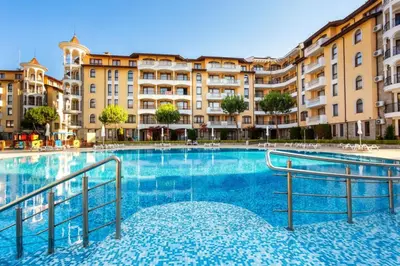 a large swimming pool in front of a building at Royal Sun Premium Apartment in Sunny Beach