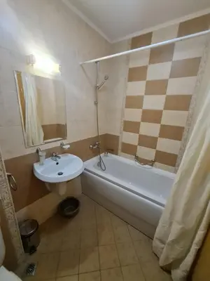 a bathroom with a sink and a tub and a toilet at Royal Sun Premium Apartment in Sunny Beach