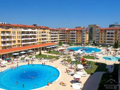 a resort with two pools and people on the beach at Royal Sun Premium Apartment in Sunny Beach