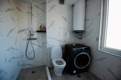 a bathroom with a toilet and a shower and a sink at Modern Spacious 1BD Apartment for two in Nesebar by Flat Mаnаger in Nesebar