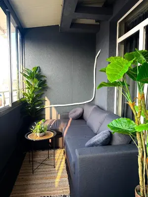 a living room with a couch and some plants at Bella Apartment - Holiday Complex Rainbow in Sunny Beach
