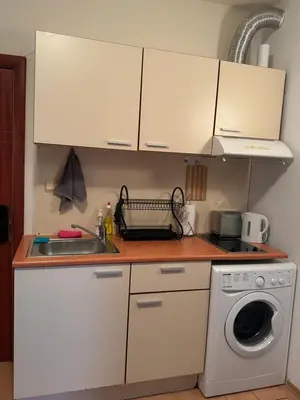 a kitchen with a sink and a washing machine at Bella Apartment - Holiday Complex Rainbow in Sunny Beach