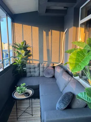 a living room with a couch and some plants at Bella Apartment - Holiday Complex Rainbow in Sunny Beach