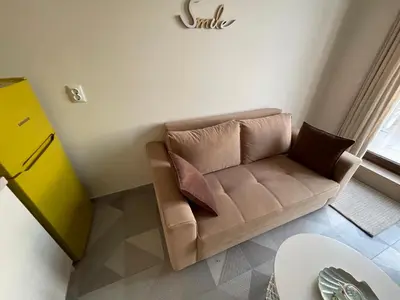 a living room with a couch with pillows on it at Romantic Getaway 1-BD Apartment with Sea View by Flat Mаnаger in Sozopol