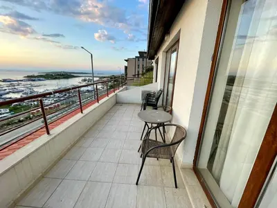 a balcony with two chairs and a table at Romantic Getaway 1-BD Apartment with Sea View by Flat Mаnаger in Sozopol