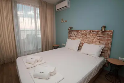 a bedroom with a bed with towels on it at Romantic Getaway 1-BD Apartment with Sea View by Flat Mаnаger in Sozopol