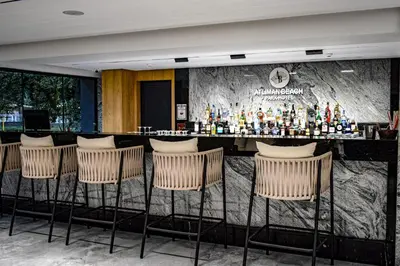 a bar in a hotel room with chairs at Atliman Beach Resort in Kiten