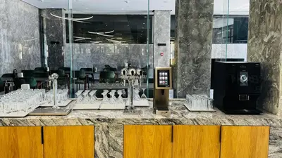 a restaurant with a counter with glasses on it at Atliman Beach Resort in Kiten