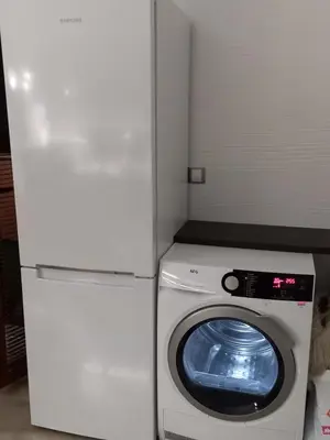 a white refrigerator and a washing machine in a room at Perla 1 apartments in Ravda