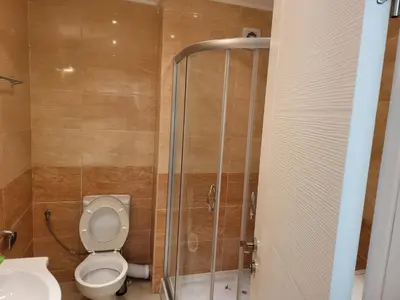 a bathroom with a toilet and a shower and a sink at Apartment on the beach 2 in Ravda