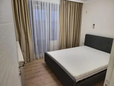 a bedroom with a bed in a room with a window at Apartment on the beach 2 in Ravda