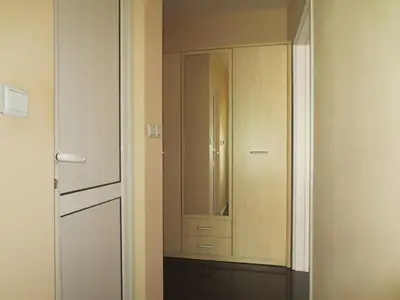 a white closet with a mirror and a cabinet at Apartment Mihaela in Burgas City