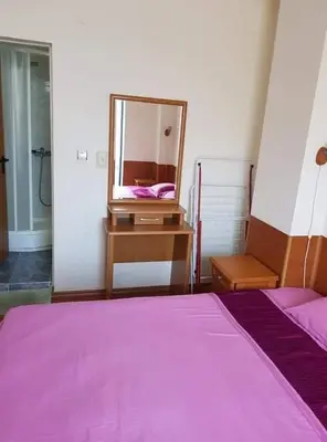 a bedroom with a purple bed and a mirror at Rainbow 1 in Sunny Beach