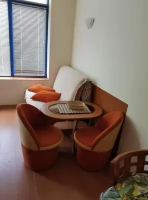 a room with a table and chairs and a bed at Rainbow 1 in Sunny Beach