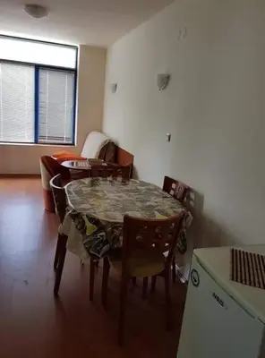 a room with a table and chairs and a kitchen at Rainbow 1 in Sunny Beach