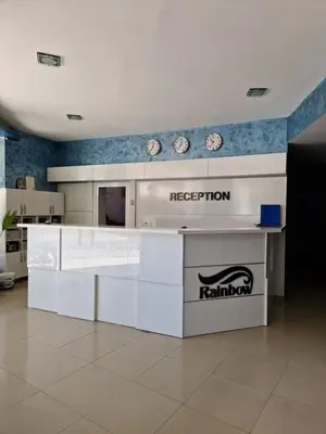 a kitchen with white counters and clocks on the wall at Rainbow 1 in Sunny Beach