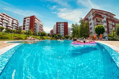 a person laying on a raft in a large swimming pool at Marina View Fort Beach in Sveti Vlas