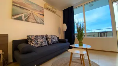 a living room with a couch and a table at ESPERANTO 401 Large Studio Sunny Beach in Sunny Beach
