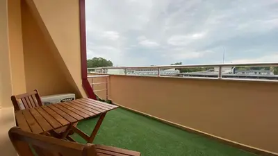 a balcony with a bench and a view of a highway at ESPERANTO 401 Large Studio Sunny Beach in Sunny Beach