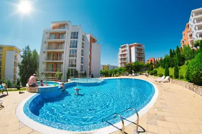 a large swimming pool in a city with buildings at Imperial Fort Club in Sveti Vlas