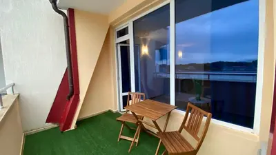 a balcony with a table and chairs and a window at ESPERANTO 402 Large Studio Sunny Beach in Sunny Beach
