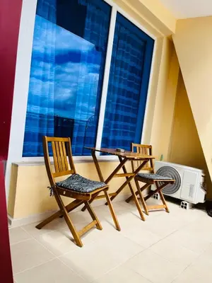 two chairs and a table in front of a window at ESPERANTO 403 Large Studio Sunny Beach in Sunny Beach