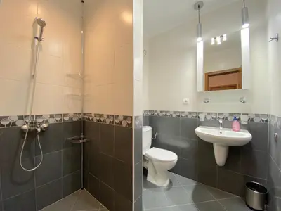 a bathroom with a shower and a toilet and a sink at Cascadas Family Resort - Private apartment - BSR in Sunny Beach