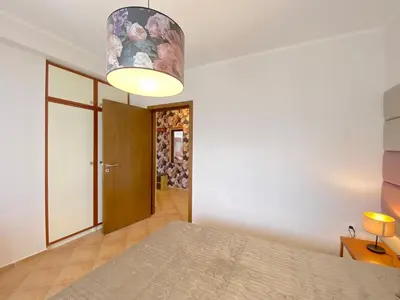 a bedroom with a bed and a lamp at Cascadas Family Resort - Private apartment - BSR in Sunny Beach