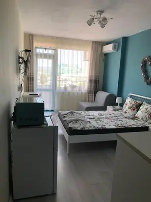 a small room with a bed and a couch at Studio N in Primorsko