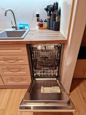 a dishwasher with its door open in a kitchen at FS Apartments Varna - Beautiful apartment in the center of Varna in Varna City