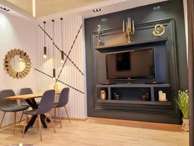 a dining room with a fireplace and a tv at FS Apartments Varna - Beautiful apartment in the center of Varna in Varna City