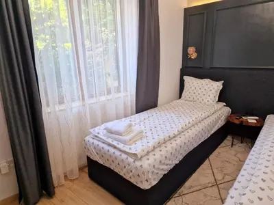 a bedroom with a bed with two towels on it at FS Apartments Varna - Beautiful apartment in the center of Varna in Varna City