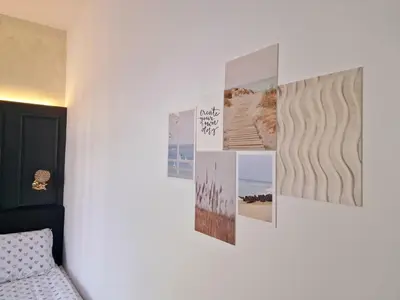 a wall with pictures on a white wall at FS Apartments Varna - Beautiful apartment in the center of Varna in Varna City