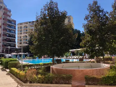 a swimming pool and trees in a city at Menada Admiral Plaza Apartaments in Sunny Beach