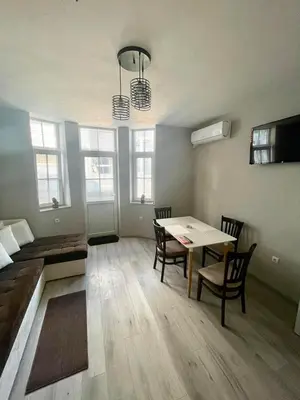 a living room with a table and a couch at Dream in Varna City
