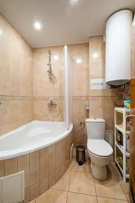 a bathroom with a toilet and a bath tub at Roman Thermae 2bdrm Sunny Apartment in Varna City