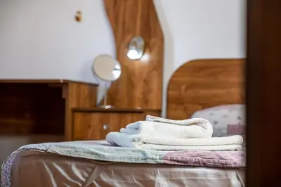 a pile of towels sitting on top of a bed at Roman Thermae 2bdrm Sunny Apartment in Varna City