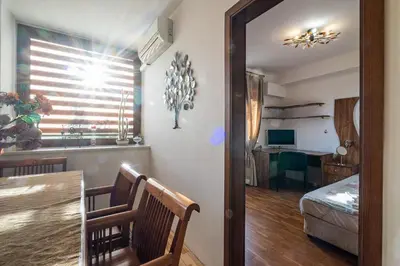 a living room with a table and a dining room at Roman Thermae 2bdrm Sunny Apartment in Varna City