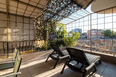 a balcony with chairs and a window with plants at Roman Thermae 2bdrm Sunny Apartment in Varna City