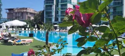 a large swimming pool with a pink rose in front of it at F 207 Primorsko del Sol - просторно студио с кухня in Primorsko