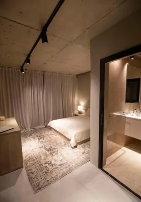a bedroom with a bed and a mirror at Luxury Villas Giardino Lozenetz in Lozenets