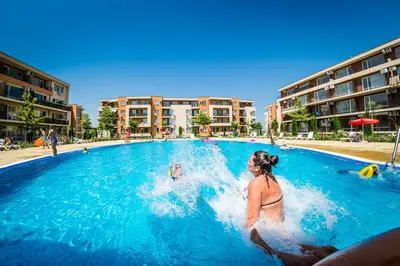 a woman in the swimming pool at a resort at Holiday Garden Resort in Sunny Beach