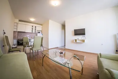 a living room with a glass table and chairs at Holiday Garden Resort in Sunny Beach