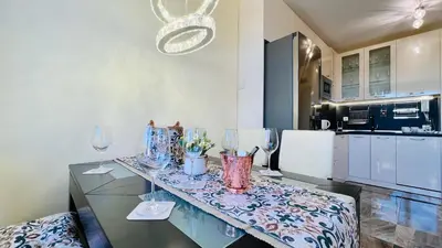a kitchen with a table with wine glasses on it at Bratanov Vip Zone maisonettes 606 & 609 in Sunny Beach